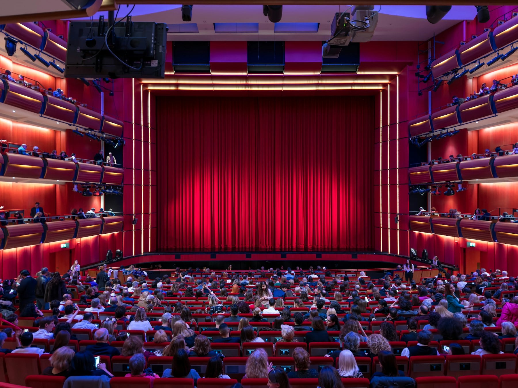 Public réuni dans une salle de spectacle avant une représentation